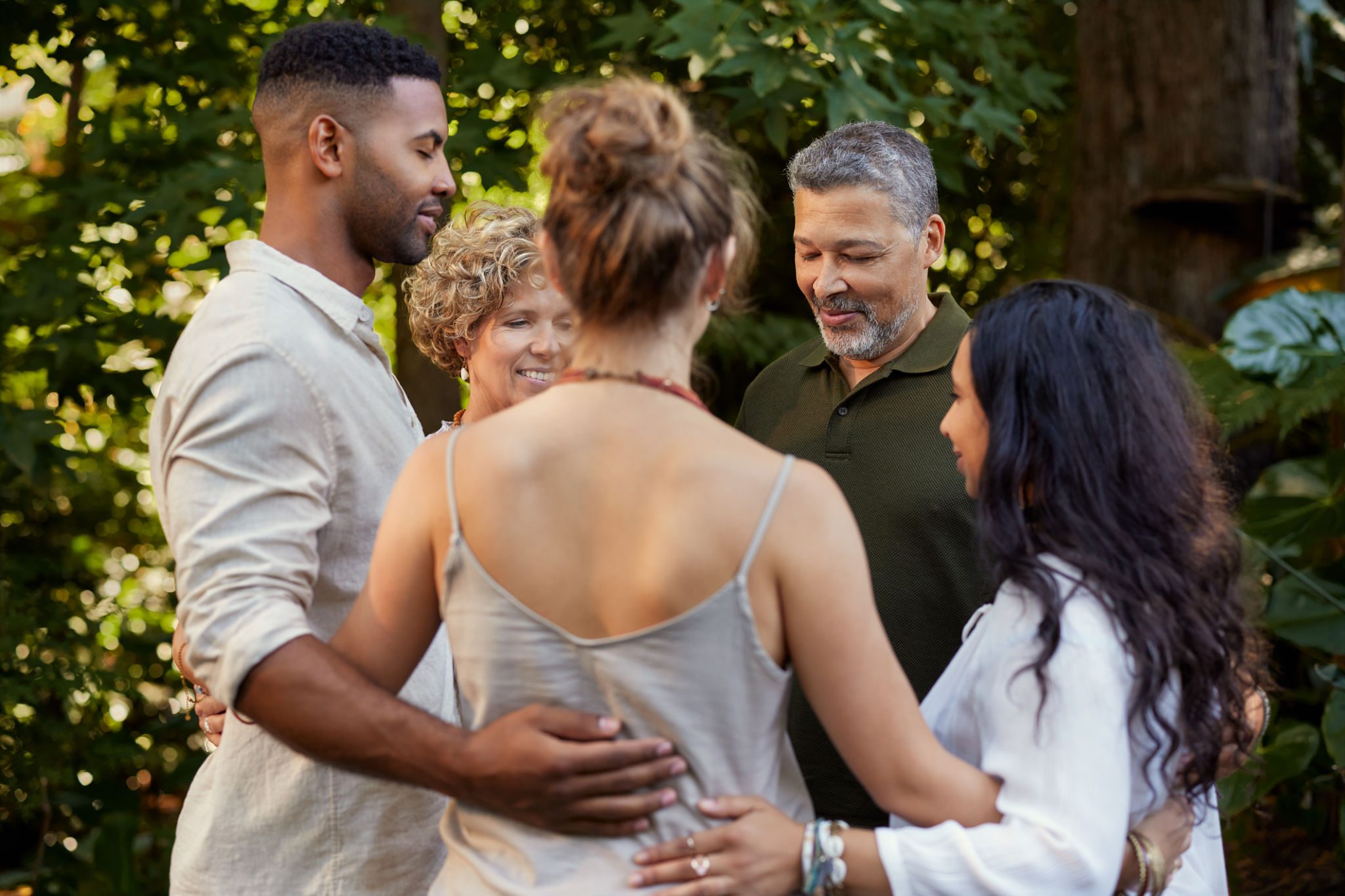 Group embracing outdoors in nature