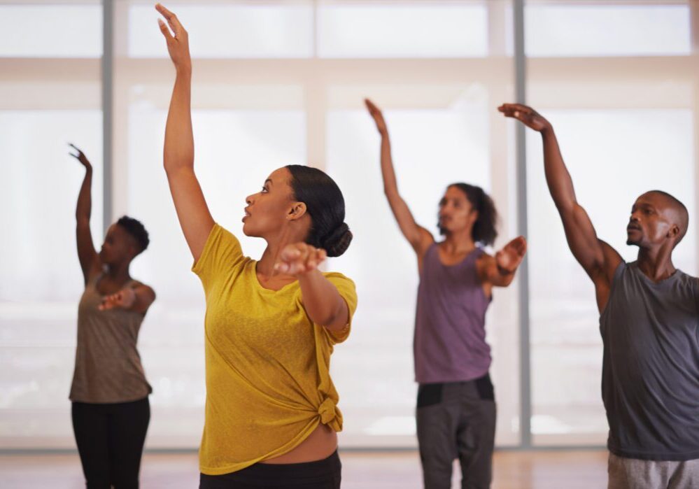 Shot of a group of young people practicing in a dance studio