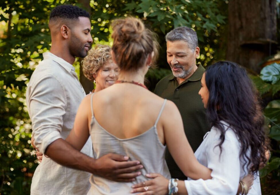Group embracing outdoors in nature